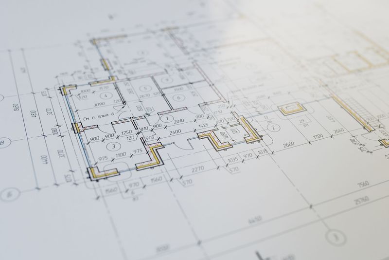 Roofing contractor reviewing a residential home exterior